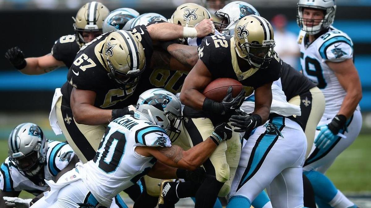 New Orleans Saints running back Mark Ingram (22) continues to fight for yardage as the Carolina Panthers defense struggles to make the tackle in the second quarter at Bank of America Stadium on Sunday, Sept. 24, 2017. The Saints won, 34-13.