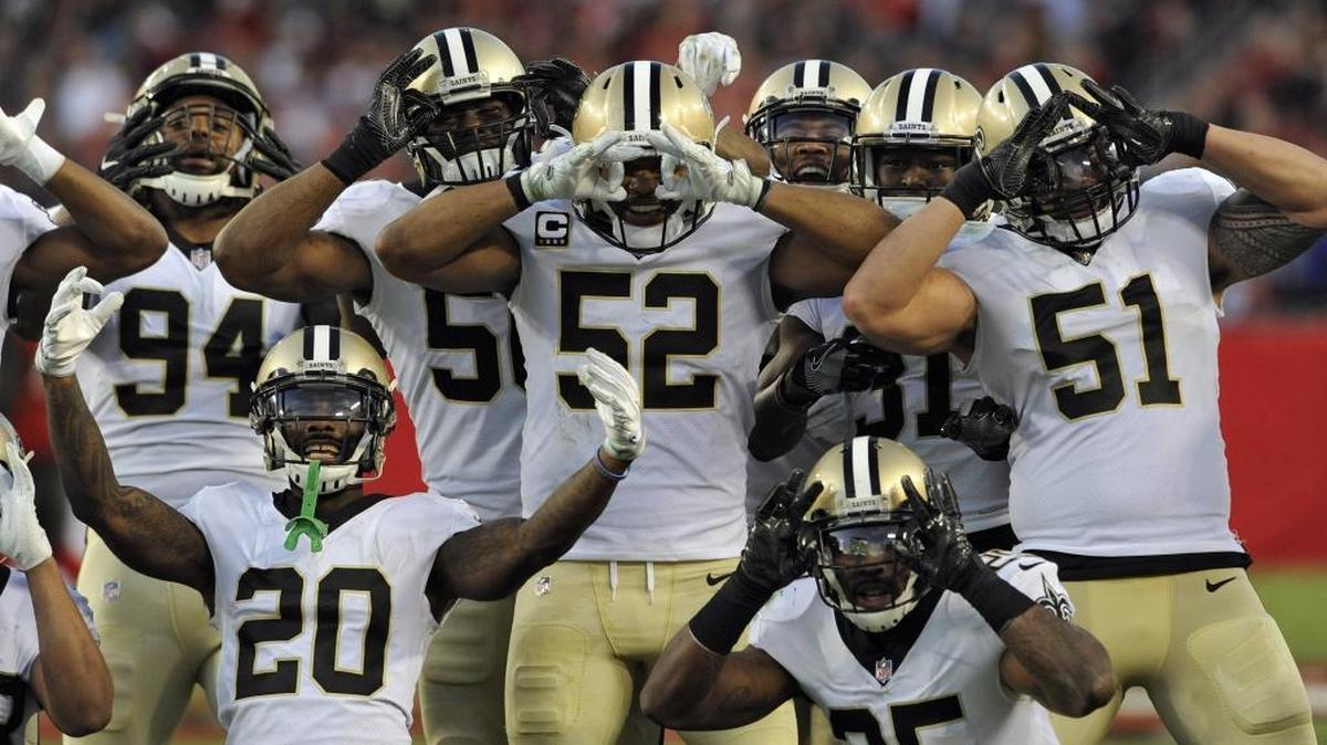 New Orleans Saints outside linebacker Craig Robertson (52) celebrates with teammates including middle linebacker Manti Te'o (51), cornerback Ken Crawley (20), defensive back Rafael Bush (25) and defensive end Cameron Jordan (94) after Robertson intercepted a pass by Tampa Bay Buccaneers quarterback Jameis Winston on Sunday in Tampa, Florida.
