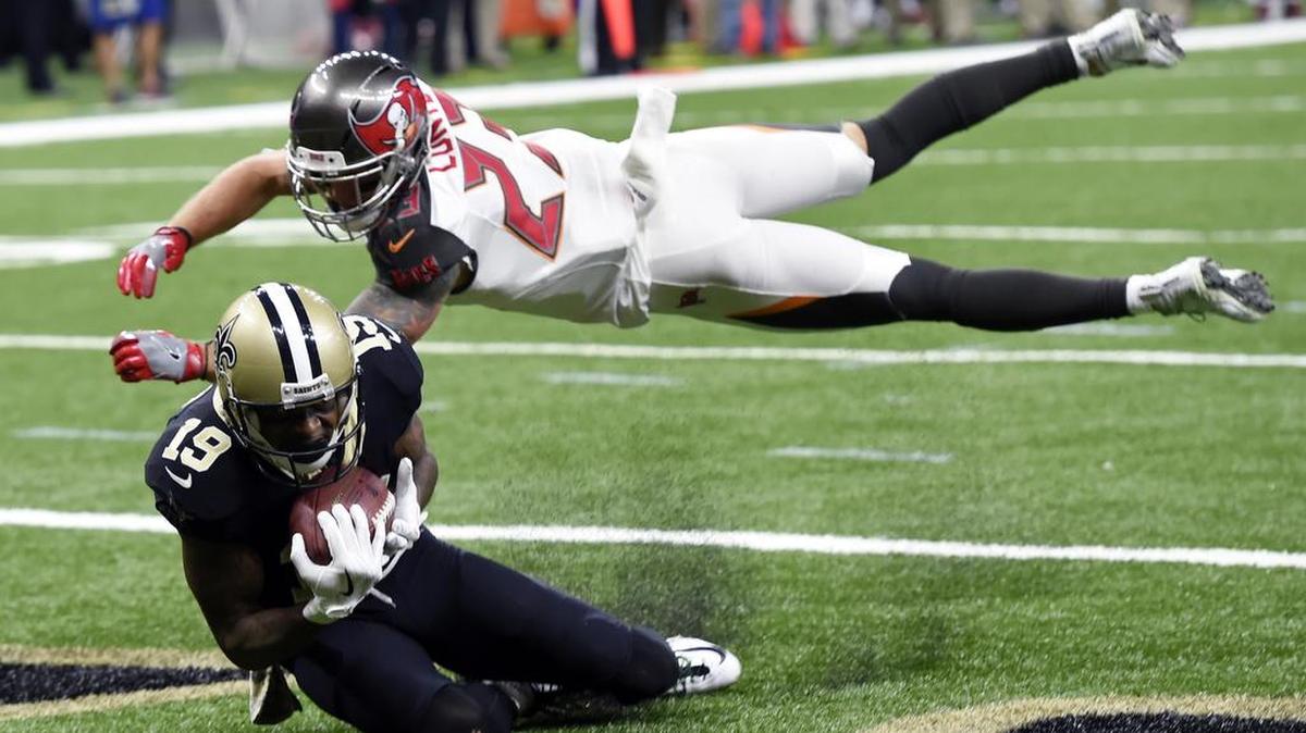 New Orleans Saints wide receiver Ted Ginn (19) pulls in a touchdown pass against Tampa Bay Buccaneers free safety Chris Conte (23).