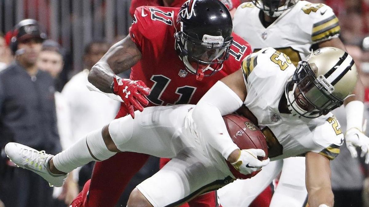 New Orleans Saints cornerback Marshon Lattimore (23) runs back an interception as Atlanta Falcons wide receiver Julio Jones (11) makes the tackle tries to make the tackle during the first half of an NFL football game, Thursday, Dec. 7, 2017, in Atlanta. The two teams will meet again on Christmas Eve.