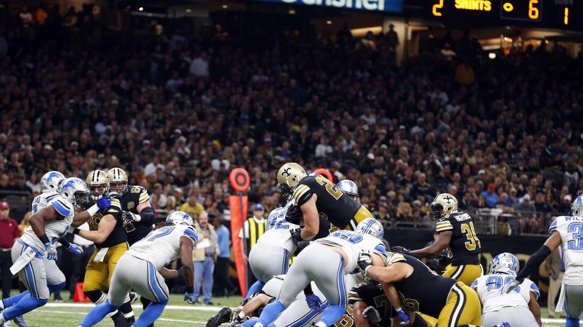 New Orleans Saints full back John Kuhn dives over the pile for a touchdown in the second half of an NFL football game against the Detroit Lions in New Orleans, Sunday.