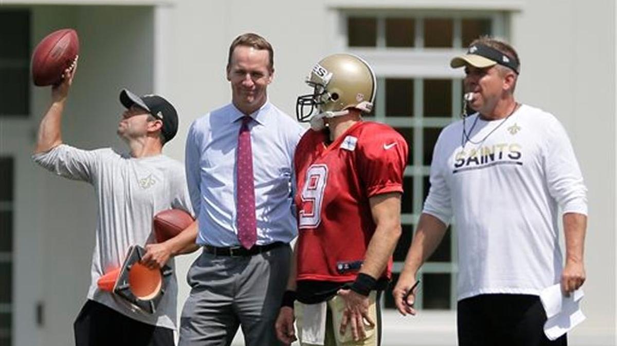 New Orleans Saints quarterback Drew Brees (9) talks with former NFL football quarterback Peyton Manning during the Saints' training camp in White Sulphur Springs, W.Va., Sunday. Manning was attending the Grocery Manufacturing Associations leadership forum, also hosted by the luxury Greenbrier Resort, where the Saints are holding training camp for a third straight summer.