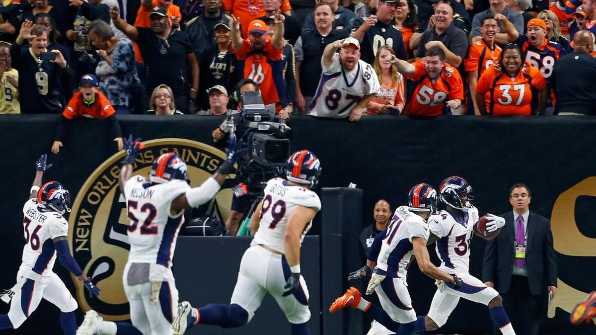 Denver Broncos defensive back Will Parks celebrates in the end zone with teammates after returning a blocked extra point for a safety in the second half of an NFL football game against the New Orleans Saints. Denver won 25-23.