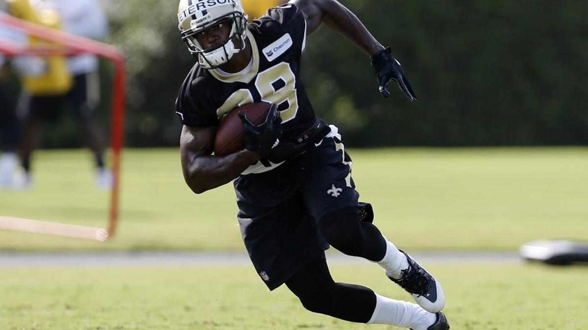 New Orleans Saints running back Adrian Peterson (28) runs with the ball during an NFL football training camp in Metairie, La., Friday, July 28, 2017.