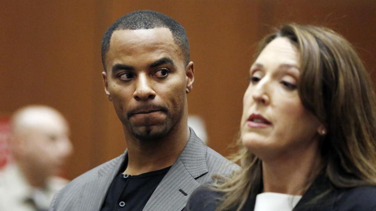 FILE - In this Feb. 20, 2014, file photo, Darren Sharper looks toward his attorney, Blair Berk, during an appearance in Los Angeles Superior Court in Los Angeles. The former NFL football star's tour of shame and punishment reached its conclusion in the Los Angeles courtroom where he first admitted drugging and raping women in several states. Sharper was sentenced Tuesday, Nov. 29, 2016 to 20 years in prison, but under terms that would total about half that time in custody. However, he's been sentenced in a Louisiana federal court to 18 years.