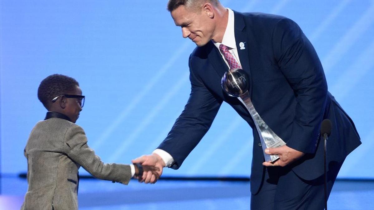 John Cena, right, presents New Orleans Saints superfan Jarrius "J.J." Robertson the Jimmy V perseverance award at the ESPYS at the Microsoft Theater on Wednesday, July 12, 2017, in Los Angeles.