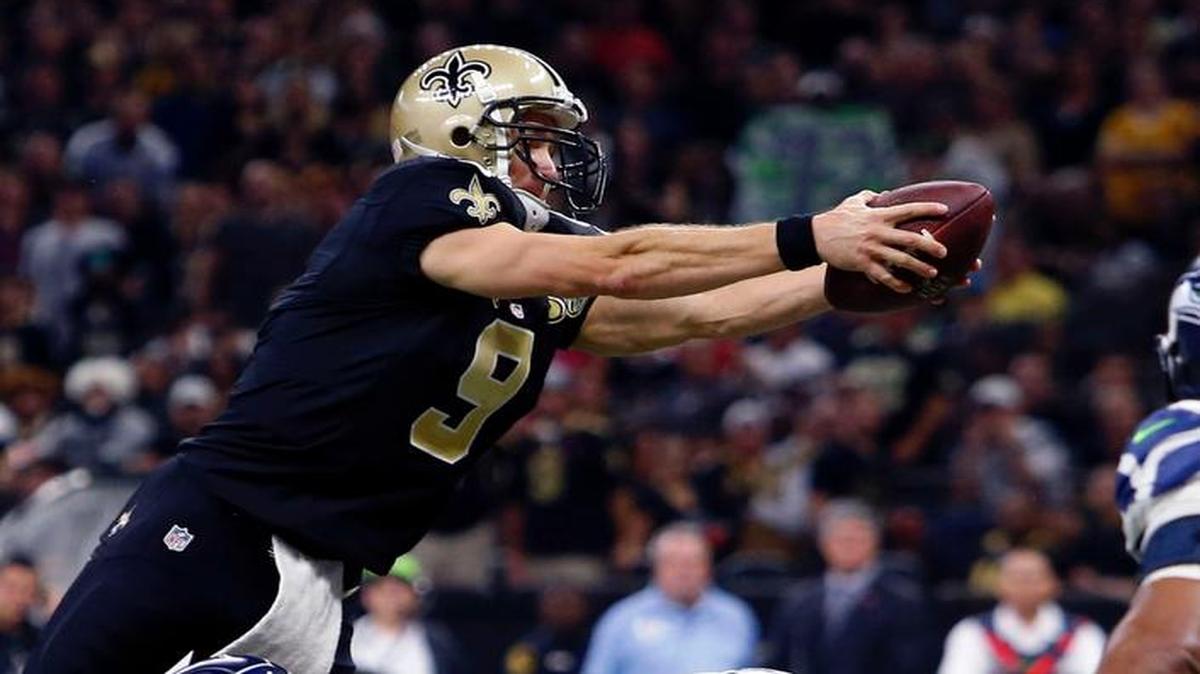 New Orleans Saints quarterback Drew Brees (9) dives over the pile for a touchdown against the Seattle Seahawks in New Orleans.