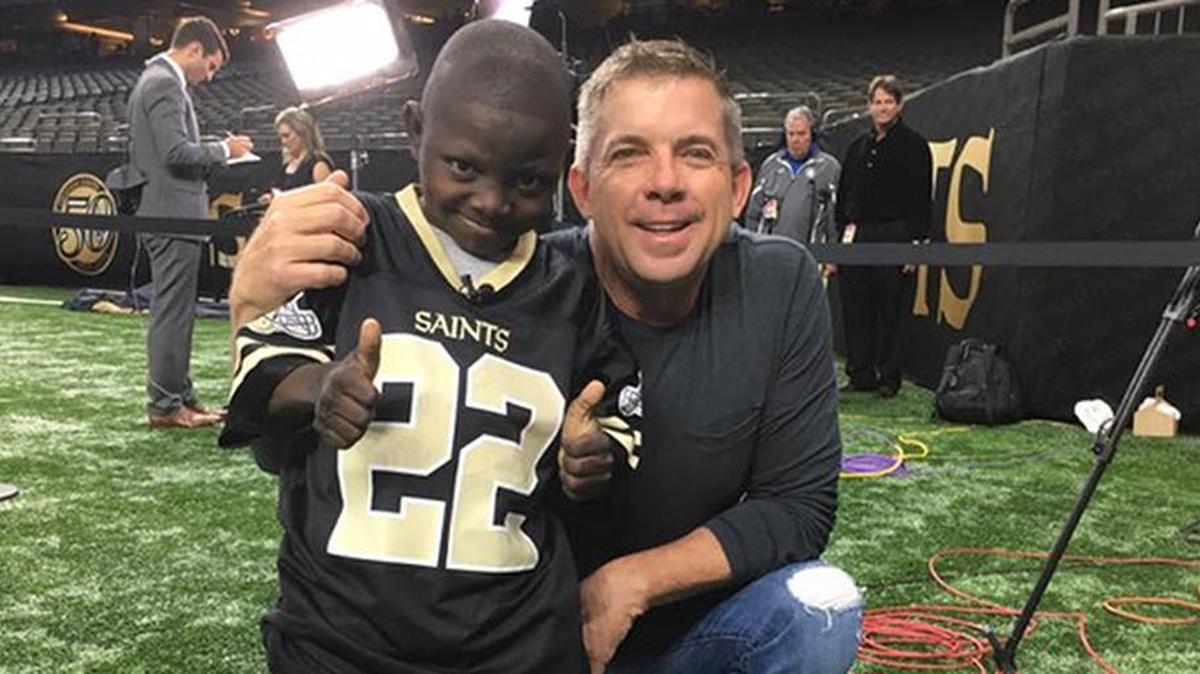 Jarrius Robertson with New Orleans Saints head coach Sean Payton.