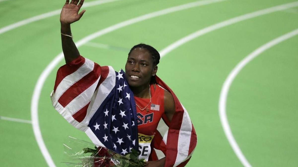 United States' Brittney Reese waves as she wears the U.S. flag after she won the women's long jump final during the World Indoor Athletics Championships on March 19, 2016, in Portland, Ore. Reese can now add OLY as a designation to her signature.
