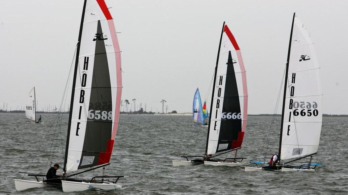 Matt Bounds, left, leads Wally Myers, center, and Phil Collins during race 10 for the Hobie 17 fleet in a previous Hobie Cat North American Championship at Ocean Springs Yacht Club.