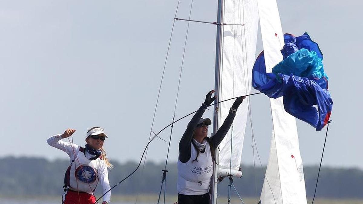 Sailors Michelle Lahrkamp and Gabriella DelBello of American Yacht Club throw out the spinnaker while in the lead during the final day of races for the U.S. Junior Women's Doublehanded Championship on Sunday, July 10, 2016, in Bay St. Louis.