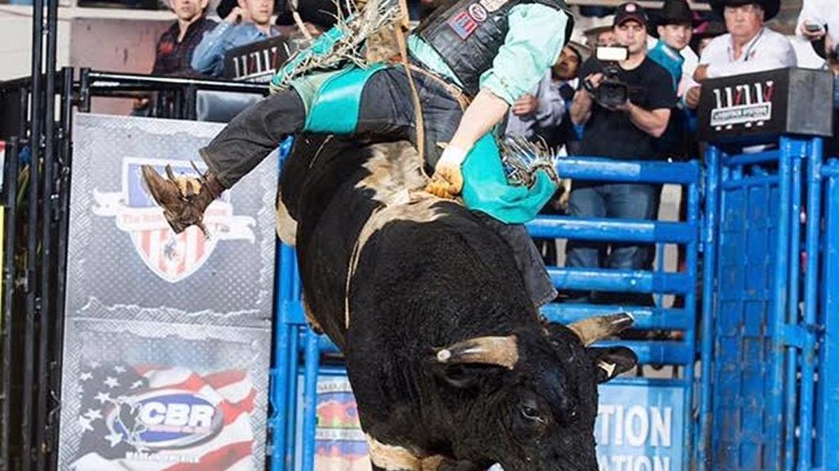 Lane Toon rides a bull owned by George County’s Colby Pepper and Justin Freeman, along with Terry Williams.
