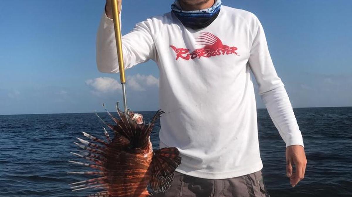 Elijah Troutman of Ocean Springs holds his new state-record Red Lionfish, which he caught Feb. 14.