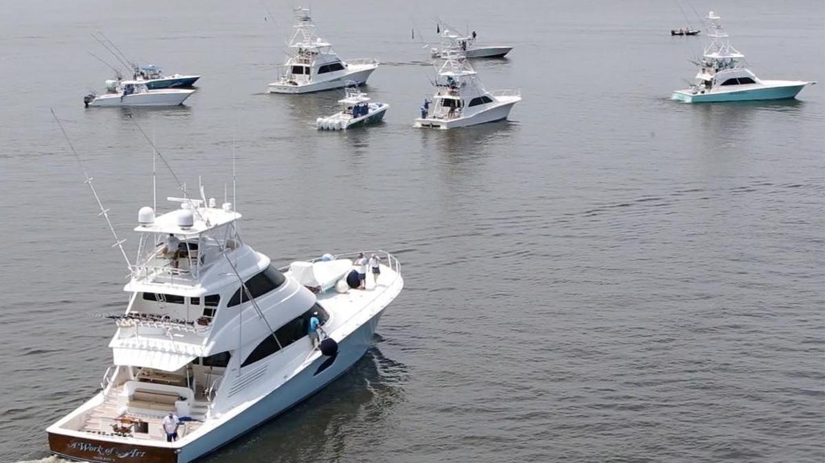 A Work of Art, bottom, leaves the Point Cadet Harbor in Biloxi for the boat parade to kick of the 2016 Mississippi Gulf Coast Billfish Classic.