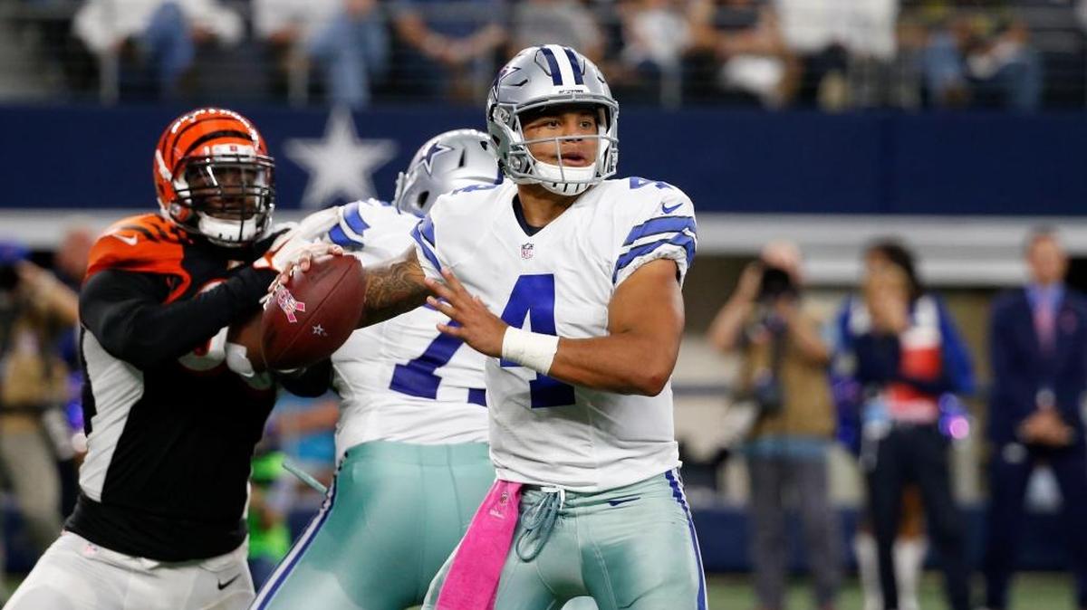 Dallas Cowboys quarterback Dak Prescott (4) prepares to throw a pass under pressure from Cincinnati Bengals defensive end Michael Johnson Sunday in Arlington, Texas.