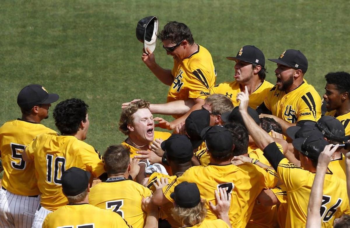 The Southern Miss team mobs Taylor Braley as he crosses home plate after hitting a two-run home run to win a come-from-behind victory over Charlotte during the USM vs. Charlotte game at the C-USA tournament. Photographer’s comment: I had an early deadline so I was already in the press box toning and putting captions on my photos. Southern Miss began its comeback. Realizing that the winning run was just hit, I grabbed my camera, put a disc in my camera and walked to the window of the press box. I gently pushed the Conference USA person aside so I could lean out the window to get the image. I was getting my exposure and focus just as the winning run crossed the plate. This was a bang, bang photo but was glad I could get it. This was the perfect picture for this game.