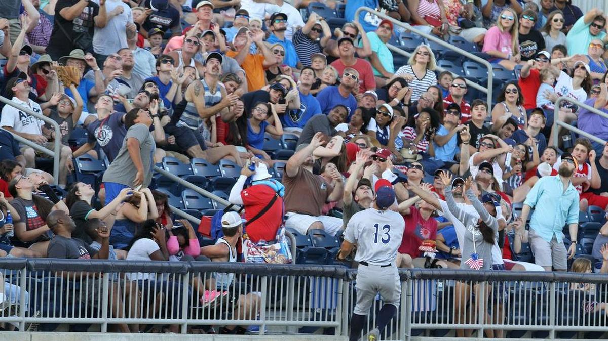 Fans reach for a foul ball during the second inning of the Biloxi Shuckers game against Pensacola game at MGM Park in Biloxi on Tuesday, July 4, 2017. Photographer's comment: This is a fun photo to look at all the different expressions of the fans' faces as they either reach for the ball hopefully or duck for cover.