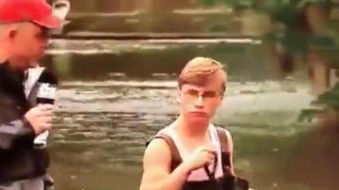 Thoroughly unimpressed by Fox News crew, Gulfport youth keeps walking dog through flood