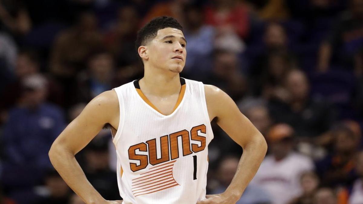 Phoenix Suns guard Devin Booker pauses during a stop in play in the second half of the team's game against the Houston Rockets on Dec. 21 in Phoenix.
