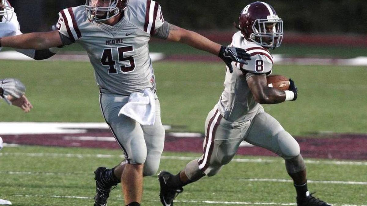 Picayune fullback Blake Merrifield blocks downfield for running back Josh Littles against Gulfport on Friday night at Lee-Triplett Stadium.
