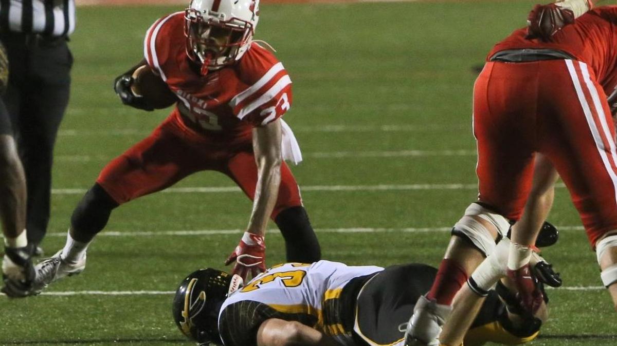 Biloxi running back Kenyatta Harrell steps over D'Iberville's Jacob Quave during the first quarter of their game at Biloxi Stadium on Friday, Sept. 22, 2016.