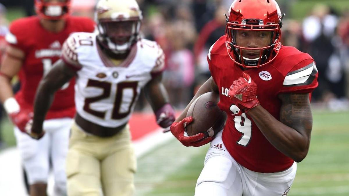 Louisville's Jaylen Smith (9) attempts to outrun the pursuit of Florida State's Trey Marshall (20) on Sep. 17 in Louisville Ky.