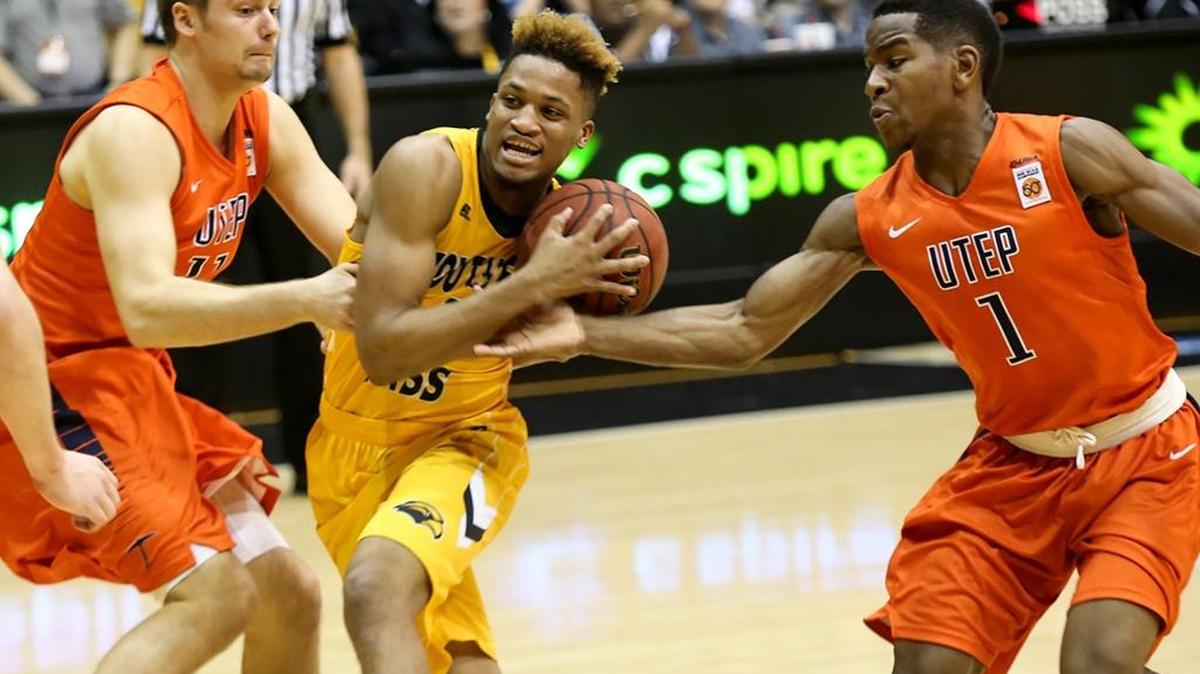 Southern Miss guard Cortez Edwards, center, attempts to break through UTEP's Jake Flaggert, left, and Dominic Artis on January 28, 2016, in Hattiesburg.