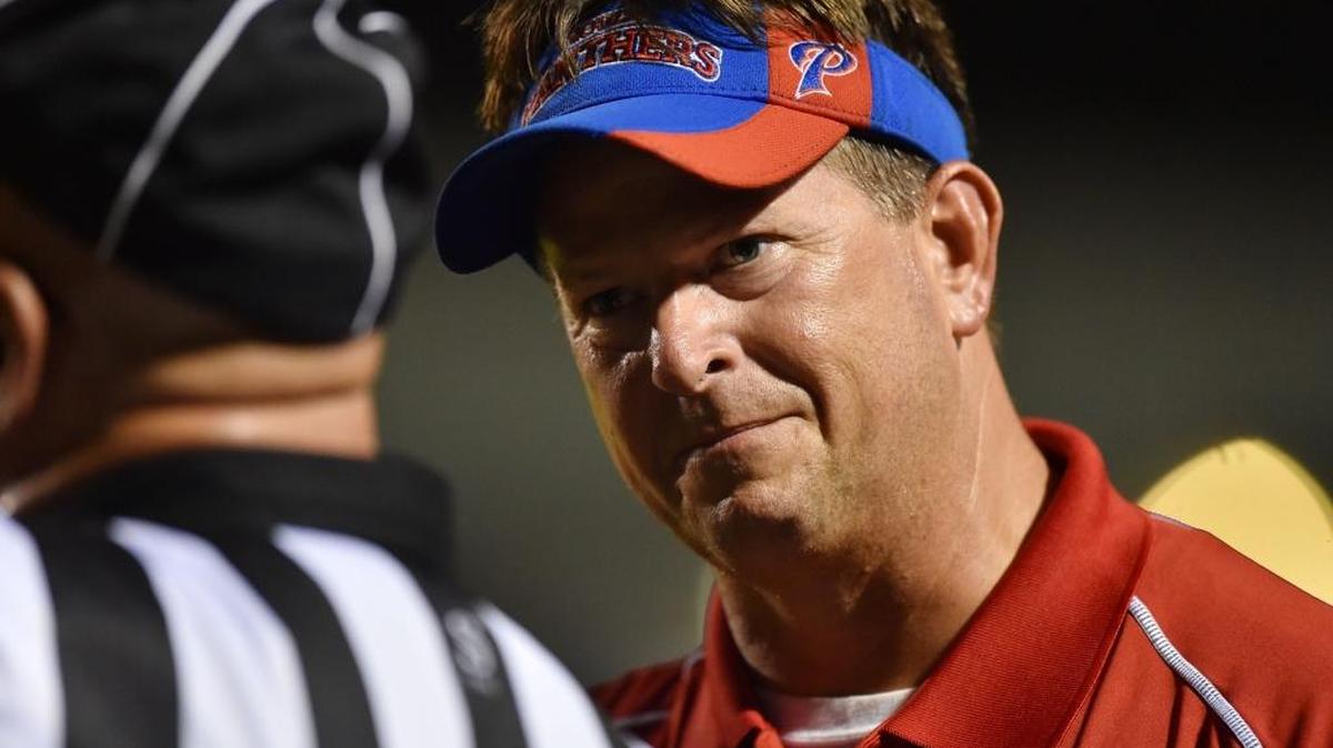 Pascagoula head coach Lewis Sims talks with an official during the second quarter against Moss Point Friday at Moss Point.