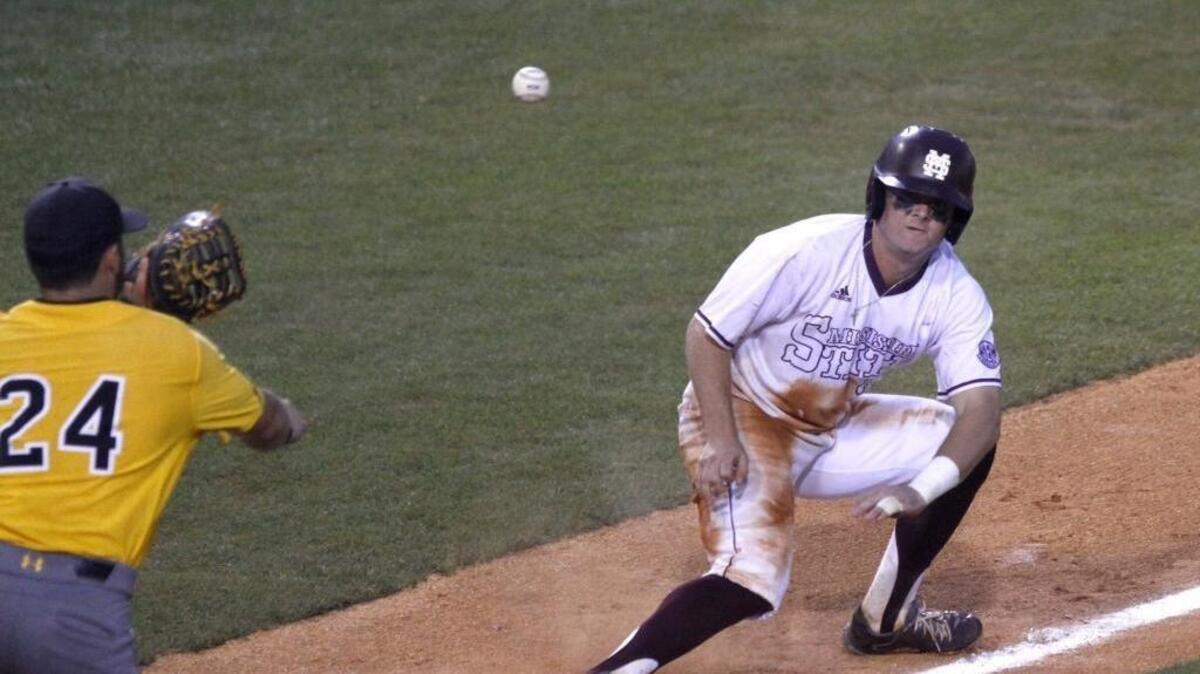 Dylan Burdeaux of Southern Miss throws to LeeMarcus Boyd as Mississippi State’s Cody Brown is caught in a run down during Hattiesburg Regional Tournament on June 5, 2017.