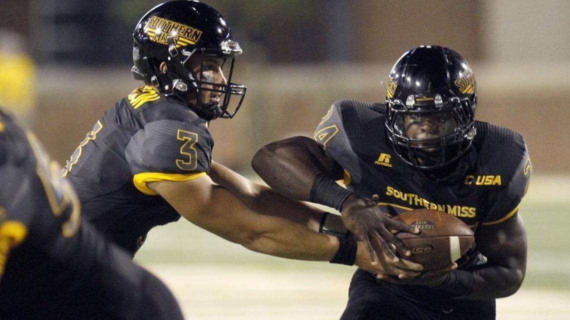 Parker Adamson of Southern Miss hands off to running back George Payne on Sept. 10 against Savannah State.