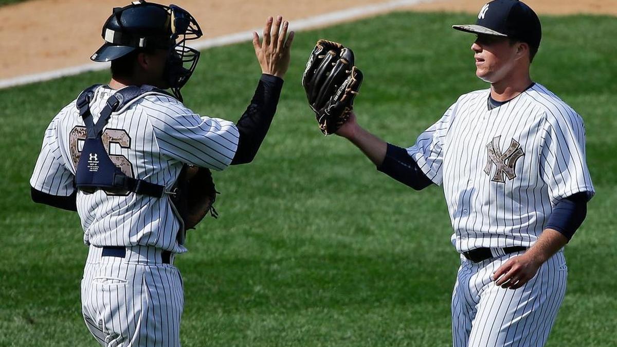 New York Yankees catcher John Ryan Murphy, left, greets pitcher Jacob Lindgren after the Yankees beat the Royals 14-1 on May 25, 2015, in New York. Lindgren made his major league debut during the eighth inning, less than a year after being drafted by the Yankees in the second round.