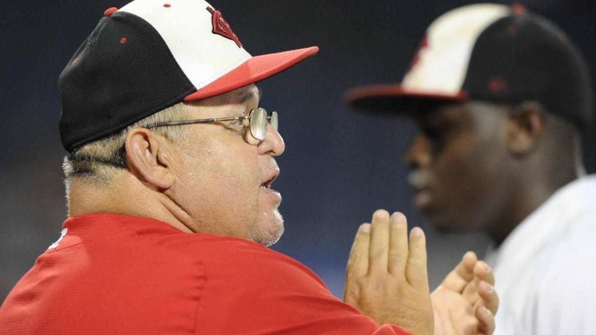Harrison Central head coach Pat Olmi tries to rally his team between innings of the state championship series in 2013.