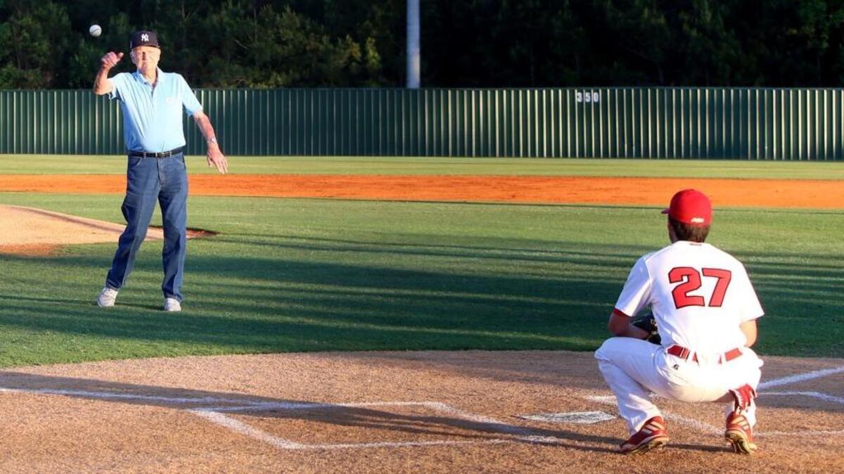 Former New York Yankee outfielder and Ole Miss legend Jack Reed pitches to Jacob Collier prior to the start of the Biloxi - St. Martin baseball game, March 21.