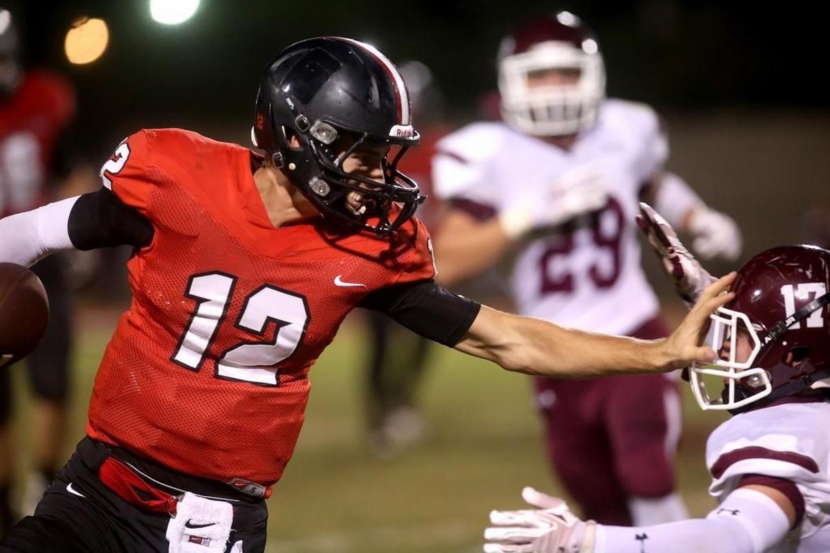 St. Stanislaus quarterback Myles Brennan runs the ball past East Central’s Taylor Carpenter on Friday, October 14, 2016, in Bay St. Louis.