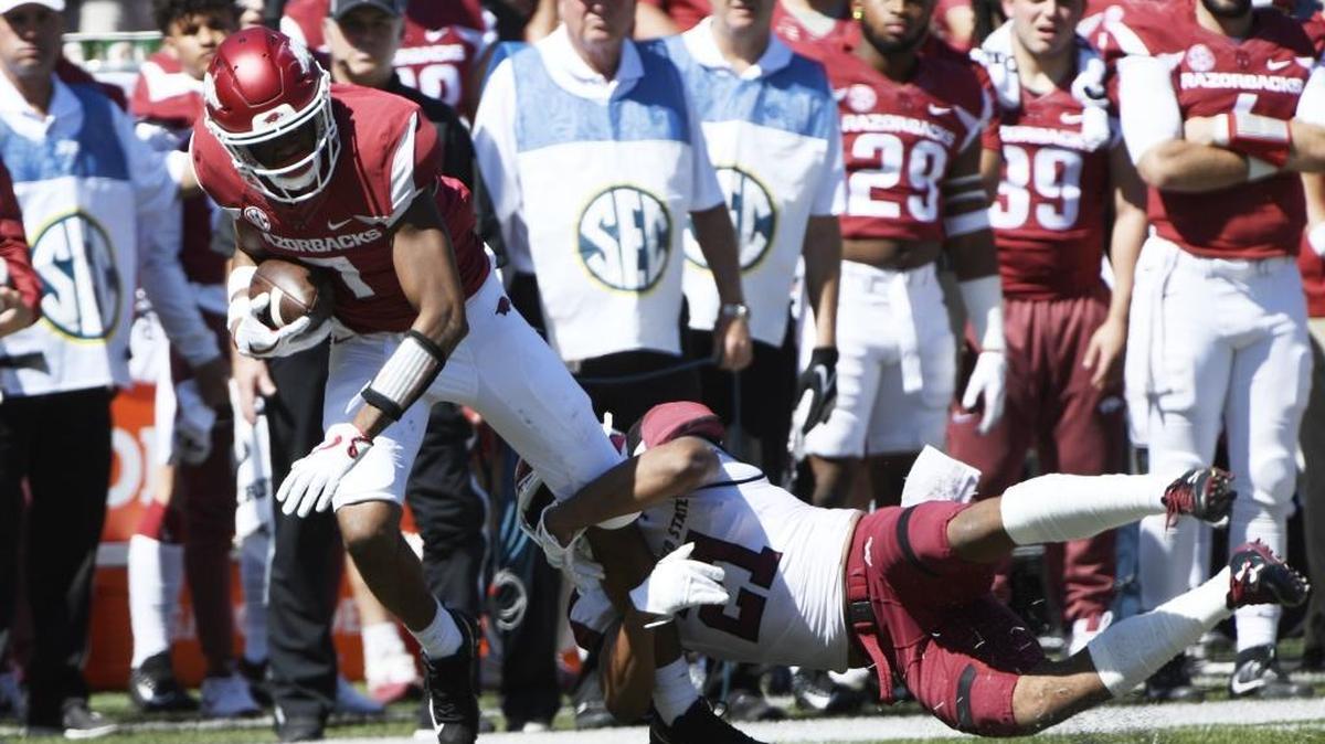 Arkansas receiver Jonathan Nance tries to shake New Mexico State defender Jaden Wright during the second half of an NCAA college football game in Fayetteville, Ark., Saturday, Sept. 30, 2017. Arkansas won the game 42-24.