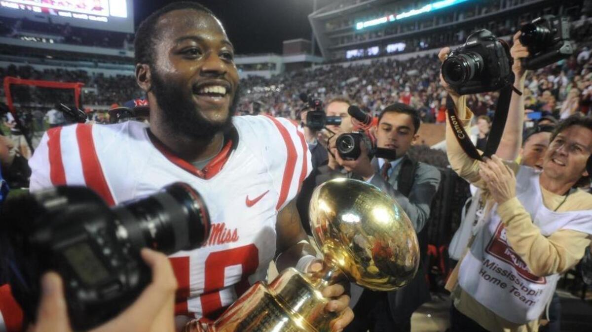 Former Ole Miss defensive standout C.J. Johnson, shown holding the Golden Egg Trophy after the Rebels beat Mississippi State 38-27 in 2015, is set to join Pearl River Community College’s coaching staff as the defensive line coach.
