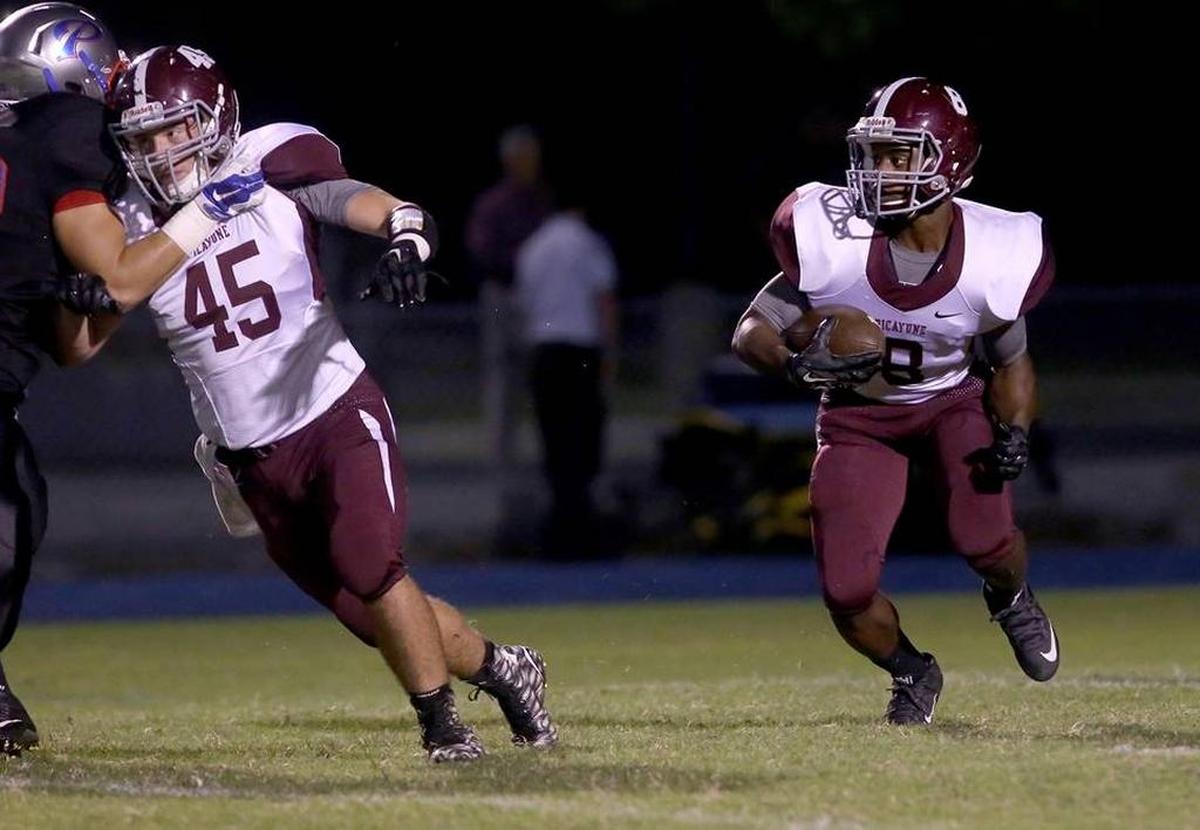 Picayune's Josh Littles runs the ball while teammate Blake Merrifield clears the way while competing against Pascagoula on Friday, October 30, 2015, at Pascagoula High.