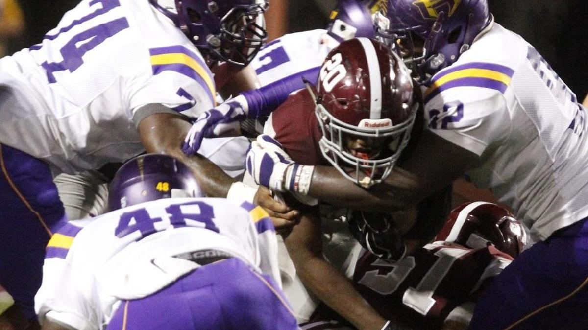 A trio of Hattiesburg defenders stop Picayune running back Shaun Anderson during the second quarter of their game at Lee-Triplett Stadium in Picayune on Friday, Oct. 20, 2017.