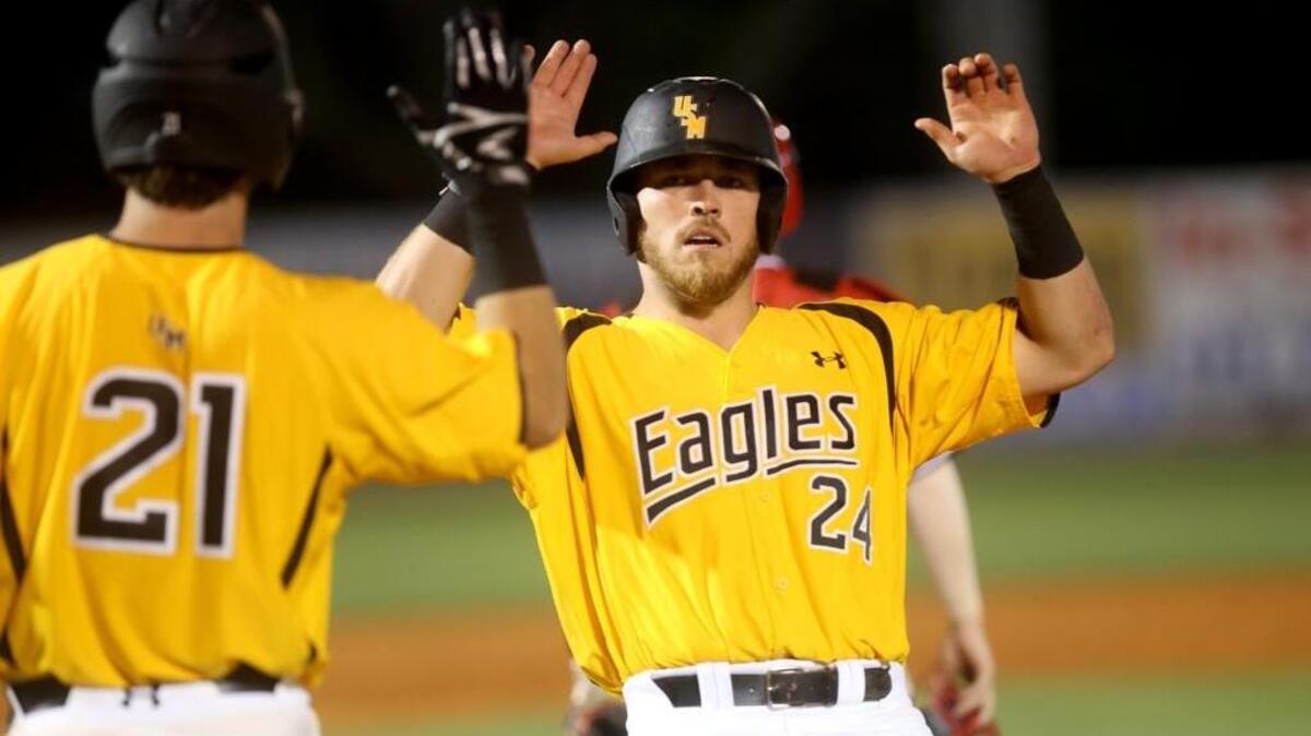 University of Southern Miss' Dylan Burdeaux, right, high fives teammate Hunter Slater after crossing home plate at MGM Park on April 18.