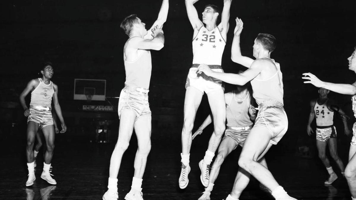 In this March 1954 file photo, Clarence "Bevo" Francis (32) of Rio Grande College, is guarded by Arizona State players during the NAIA Men's Division I Basketball Tournament in Kansas City, Mo. Francis set college basketball records for high scoring in the 1950s.