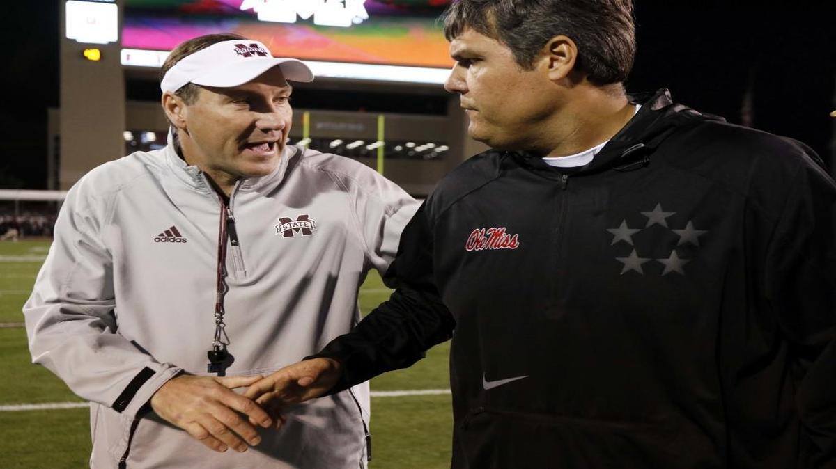 Mississippi State head coach Dan Mullen, left, and Ole Miss head coach Matt Luke wish each other good luck prior to the Egg Bowl in Starkville, Thursday, Nov. 23, 2017. In the days after the rivalry game Mullen left MSU for Florida and the Rebels announced Luke will be the full-time head coach.