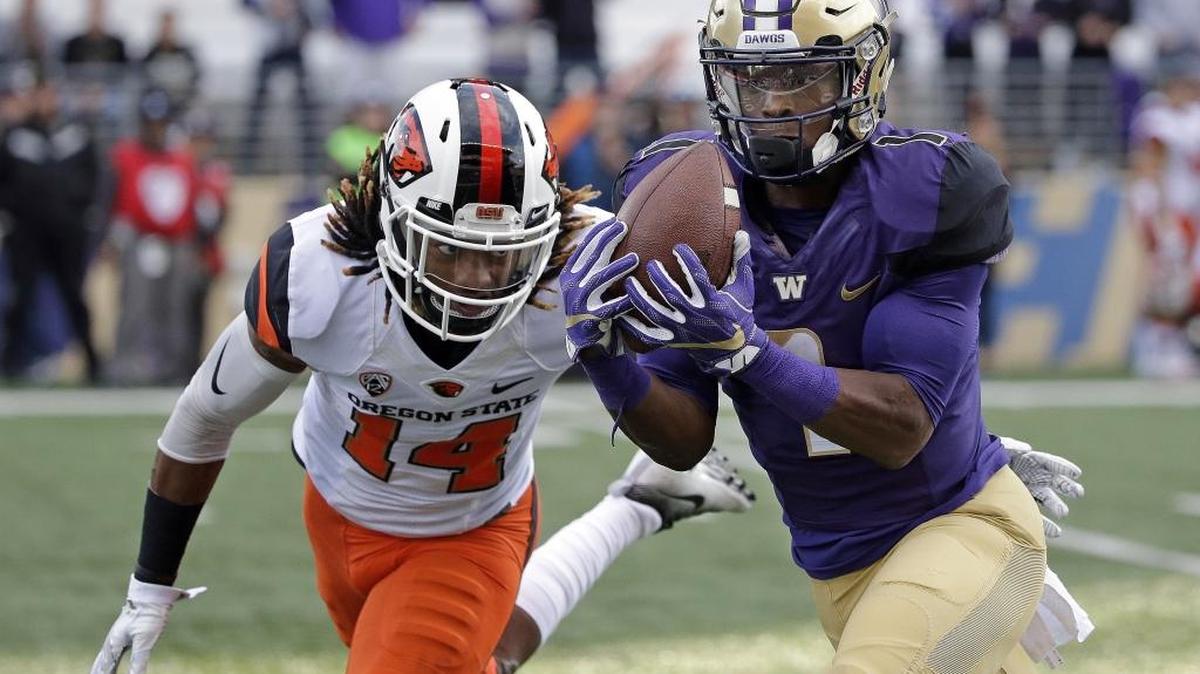 Washington's John Ross, right, makes a long pass reception in front of Oregon State's Treston Decoud. Ross was the player of the year on the Associated Press All-Pac-12 team.