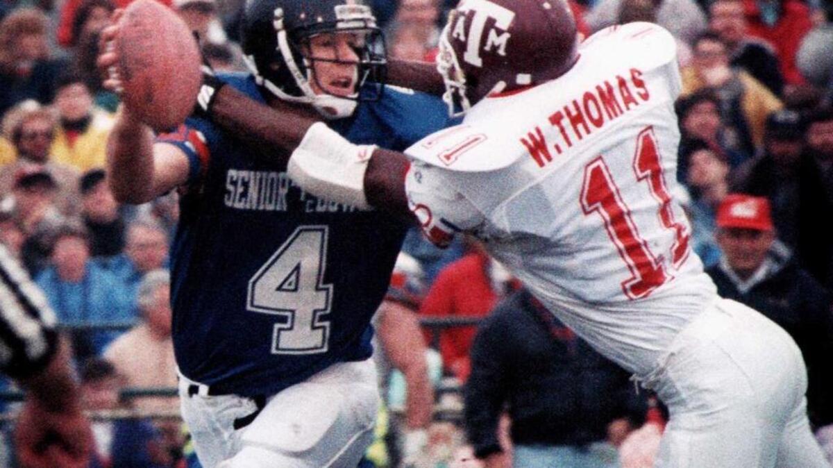 Brett Favre is pressured by Texas A&M player during the Senior Bowl in Mobile.