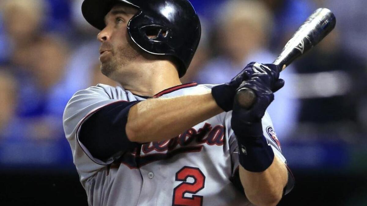 Minnesota Twins' Brian Dozier watches his solo home run off Kansas City Royals starting pitcher Edinson Volquez at Kauffman Stadium in Kansas City, Mo., Aug. 19.