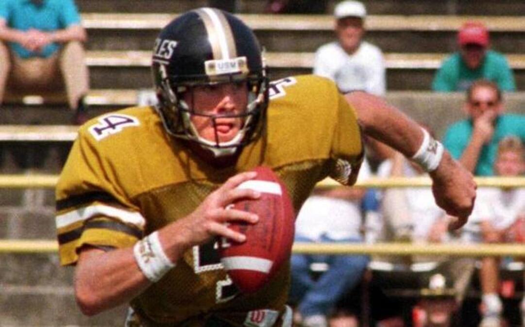 Former Southern Miss QB Brett Favre scrambles out of the pocket against Texas A&M at Jackson. Favre, a native of Fenton, began playing QB for USM midway through his freshman season and became a mainstay at the position for the Golden Eagles.