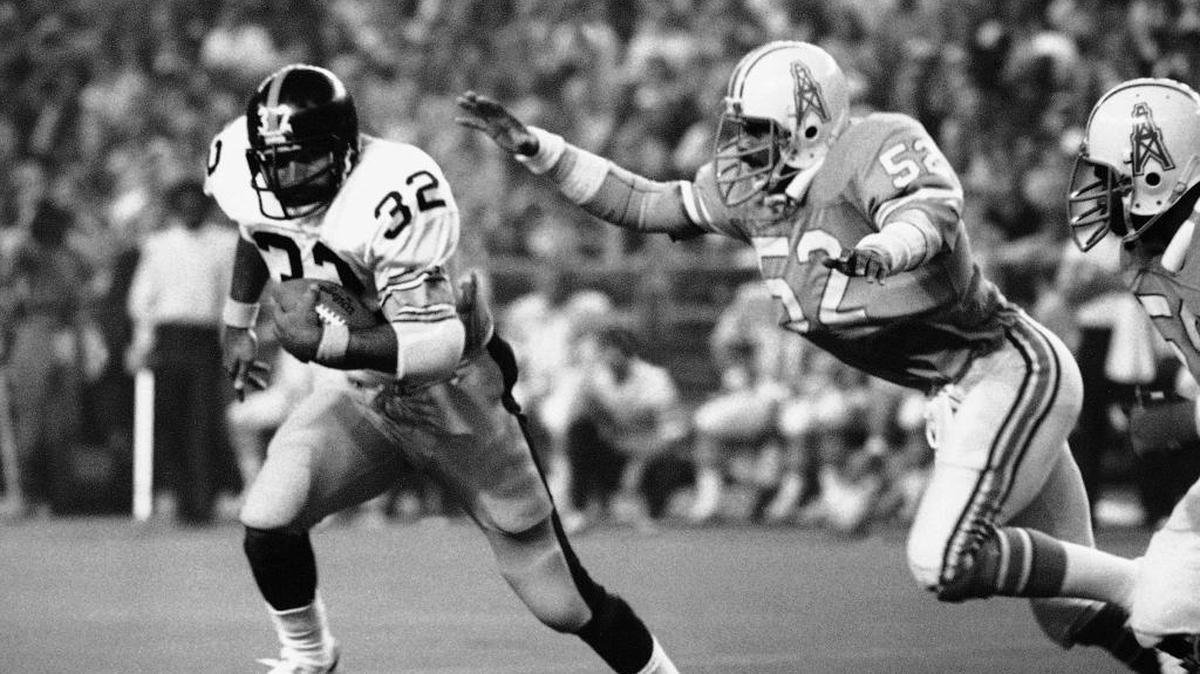 In this Dec. 3, 1978, file photo, Pittsburgh Steelers running back Franco Harris (32) picks up 10 yards as he turns the corner as Houston Oilers' Robert Brazile (52) makes a dive to latch on to Harris to make the stop, during an NFL football game in Houston. Brazile was elected to the Pro Football Hall of Fame on Saturday, Feb. 3, 2018.