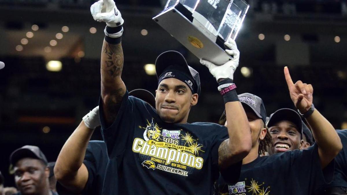 Southern Miss wide receiver Allenzae Staggers lifts up his MVP award after winning against Louisiana-Lafayette in the New Orleans Bowl on Saturday in New Orleans.