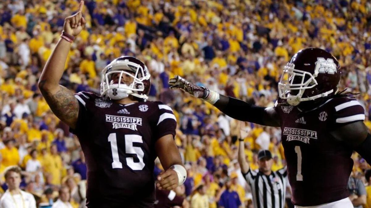 FILE - In this Sept. 20, 2014, file photo, Mississippi State quarterback Dak Prescott (15) celebrates his 56-yard touchdown run with wide receiver De'Runnya Wilson (1) against LSU in Baton Rouge, La. Mississippi State had never been ranked higher than No. 7 before the Bulldogs surged to the top of the AP poll in 2014 and stayed there for five weeks.