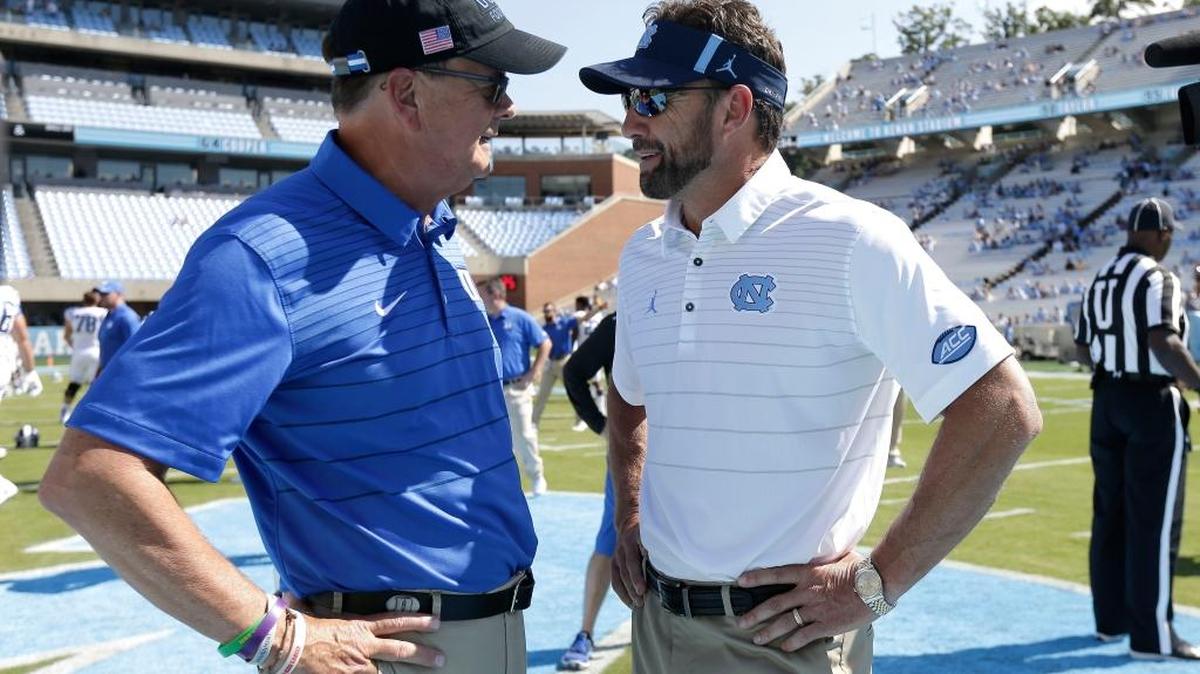 Duke coach David Cutcliffe, left, and North Carolina coach Larry Fedora speak prior to playing in Chapel Hill, N.C., Saturday, Sept. 23, 2017.