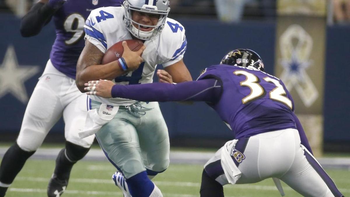 Dallas Cowboys quarterback Dak Prescott (4) tackled by Baltimore Ravens strong safety Eric Weddle, Sunday, Nov. 20, in Arlington, Texas.